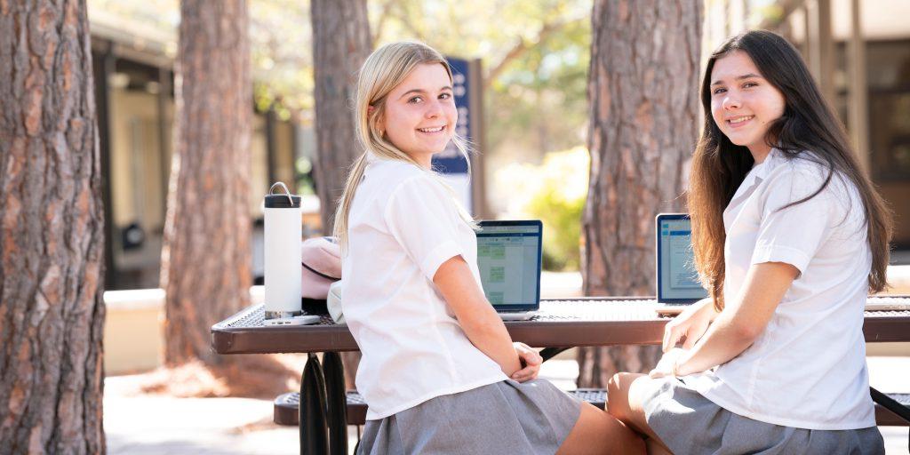 two girls sitting outside at a table, private school, tampa fla